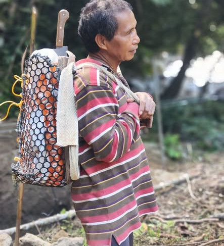 villager carrying materials behind his back, with a bag repurposed from waste
