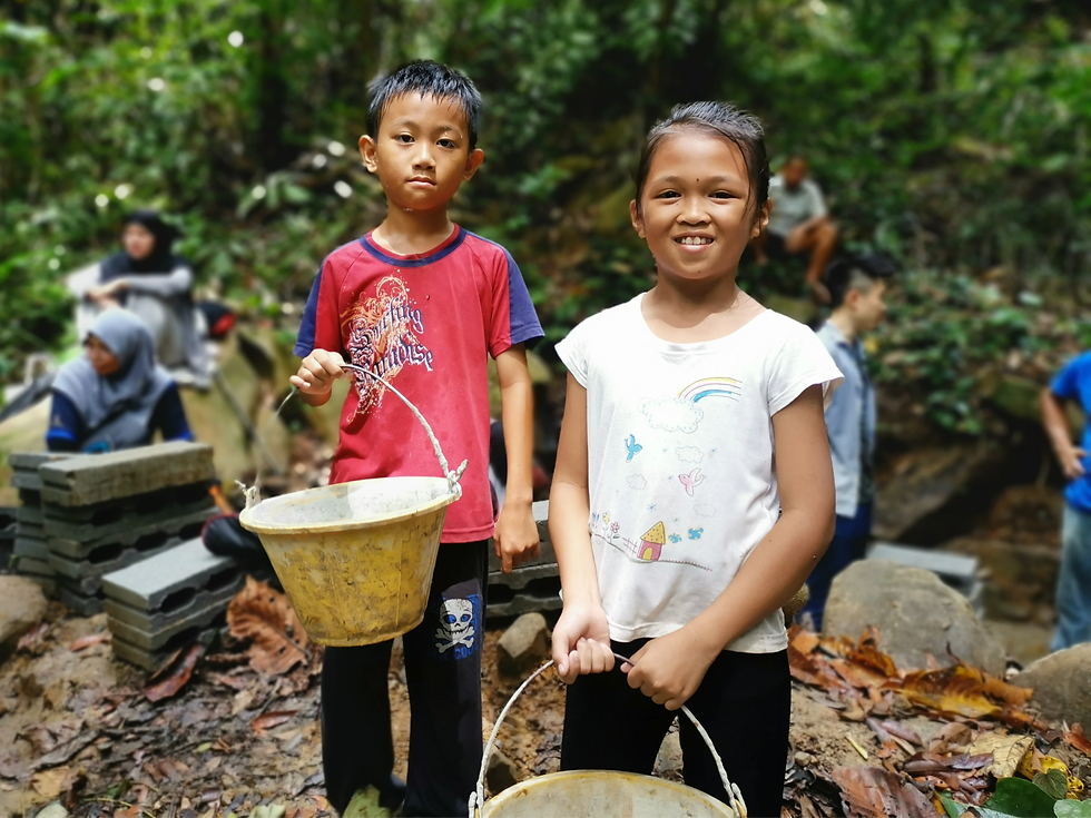 rural children helping out with their community's water project