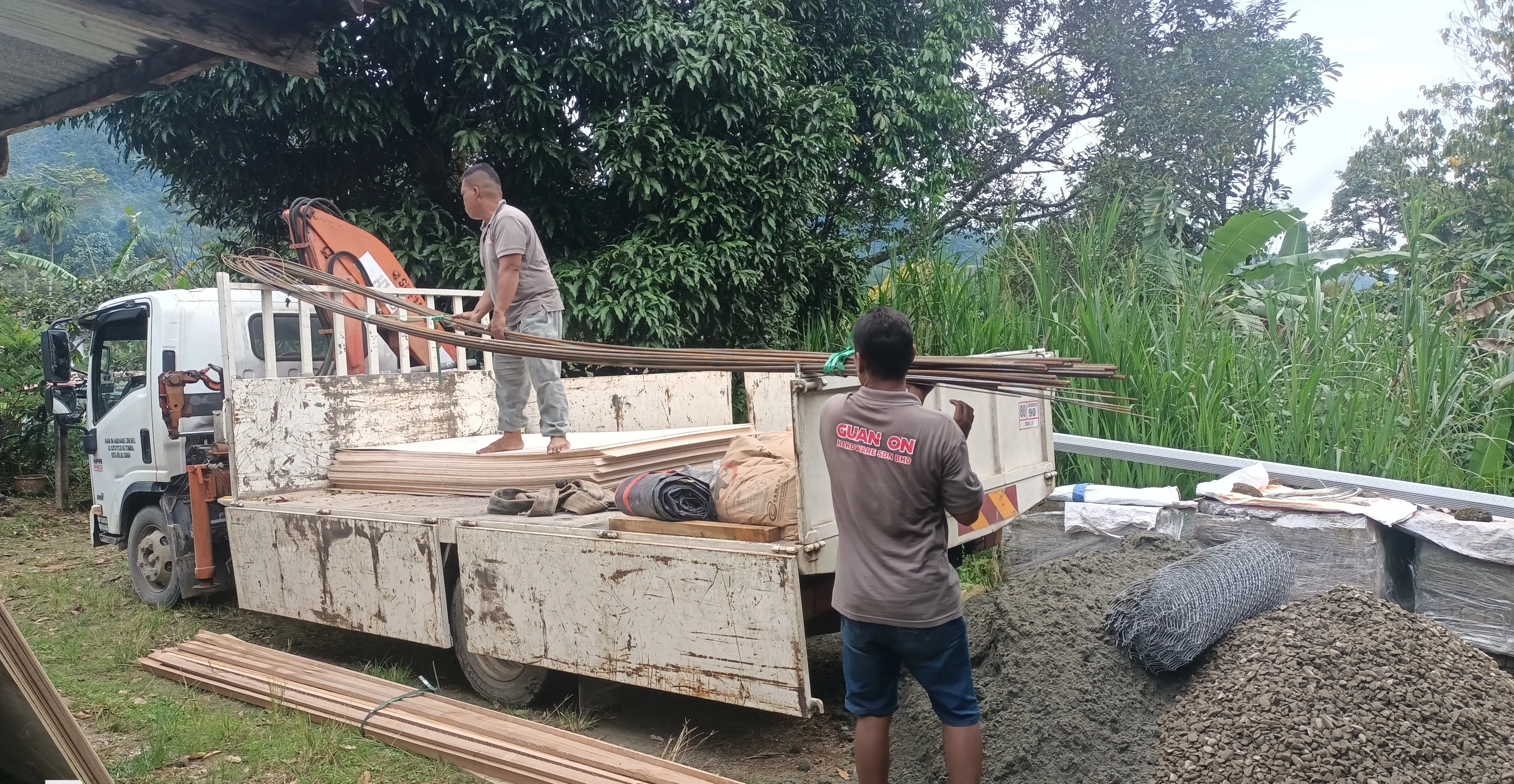workers unloading the bridge repair materials at the community's site
