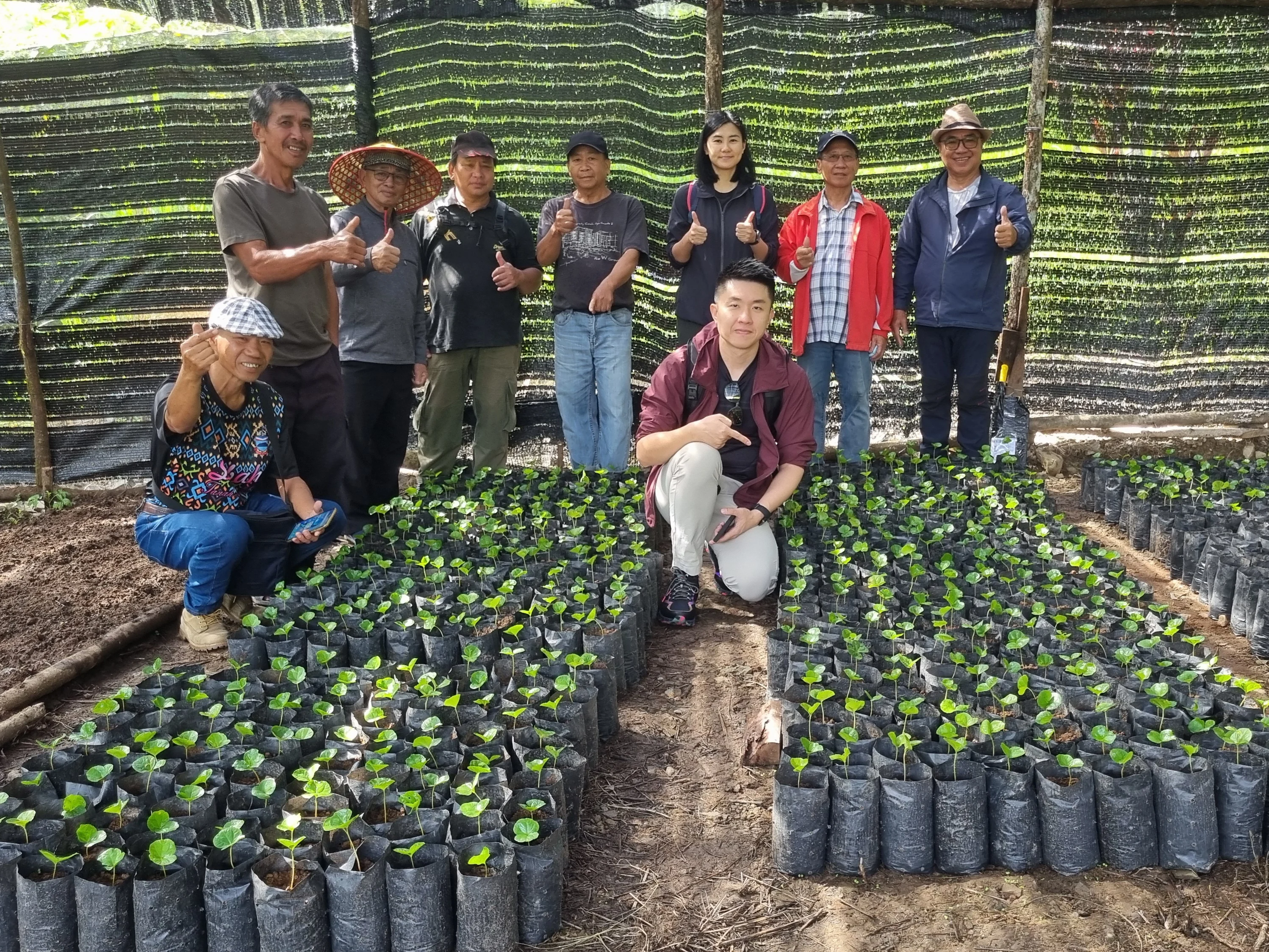 Our team with the coffee farmers at their farm. 