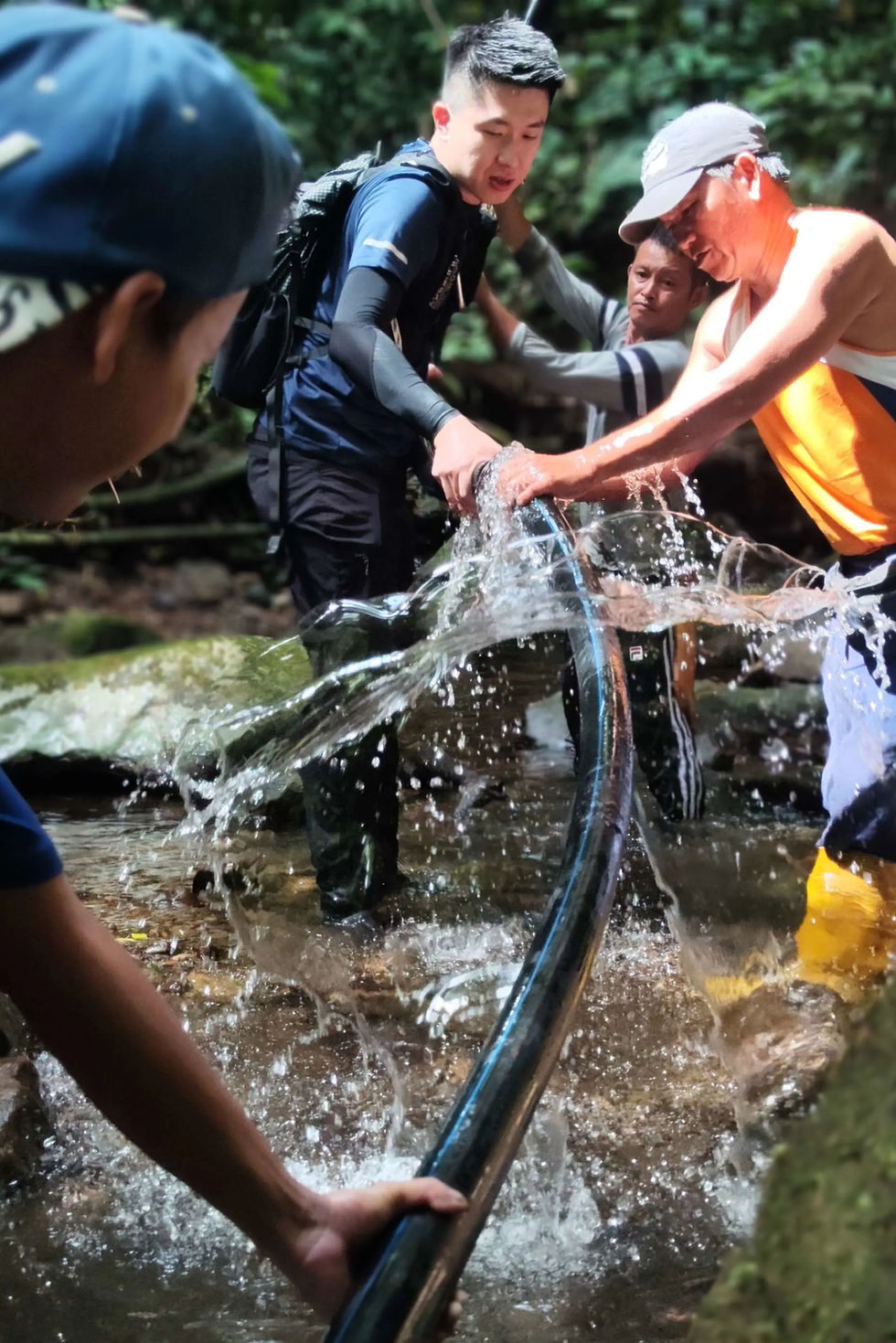 Sam and rural farmers working together connect pipes.webp