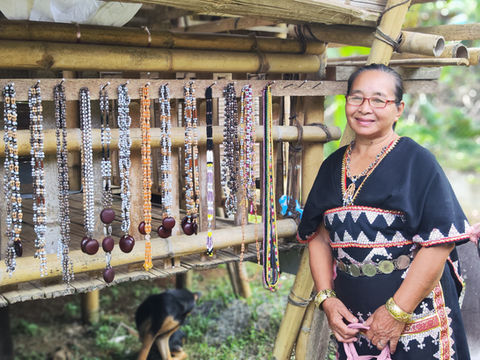 Smiling woman showing her handmade accessories