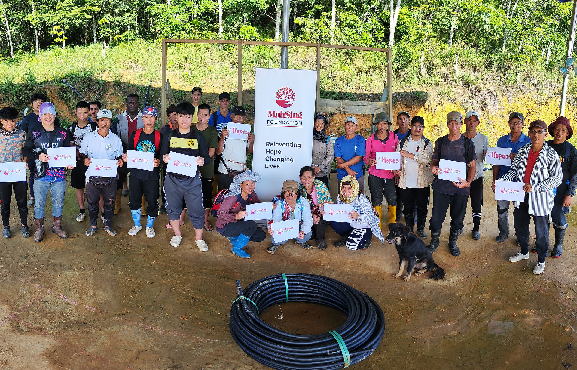 Rural villagers with the project materials supported by Mah Sing Foundation for their water project.