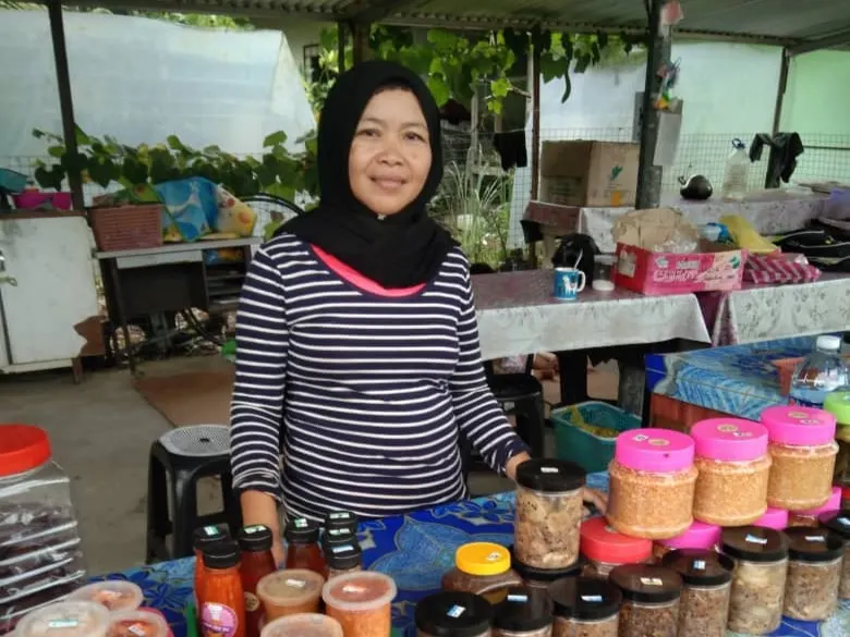 Rural farmer with a glimpse of the homemade products made by all the rural women, to be sold at the stall