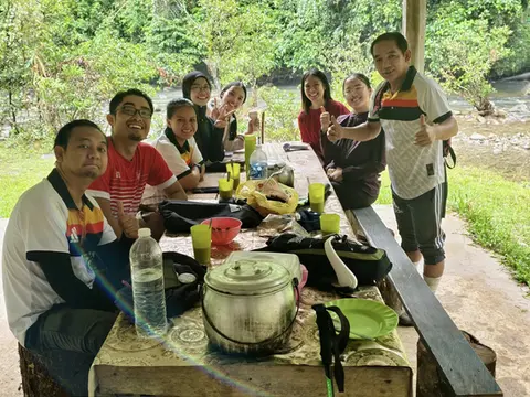 A group of people getting ready to enjoy their meal after a sweaty hike.