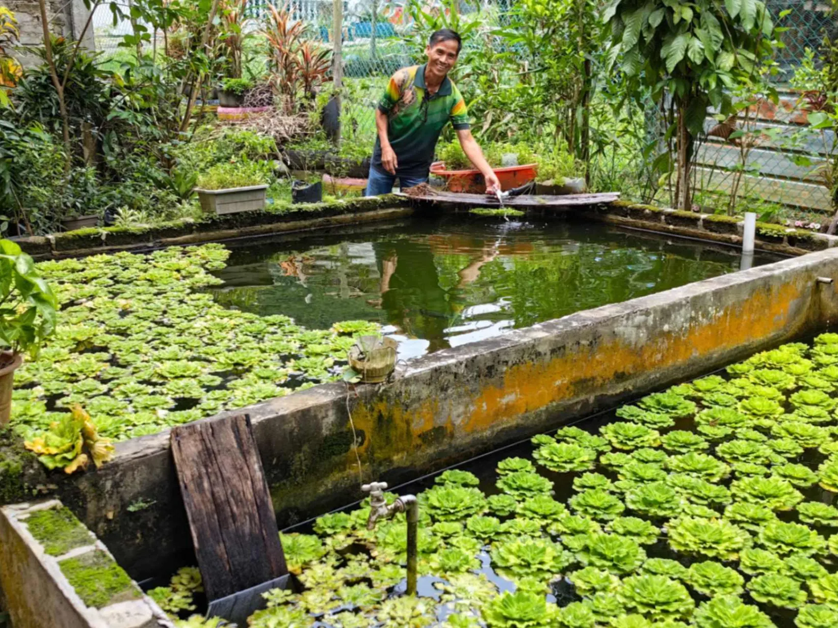 One of Hopes Malaysia's rural farming beneficiaries standing proudly by his fish pond.