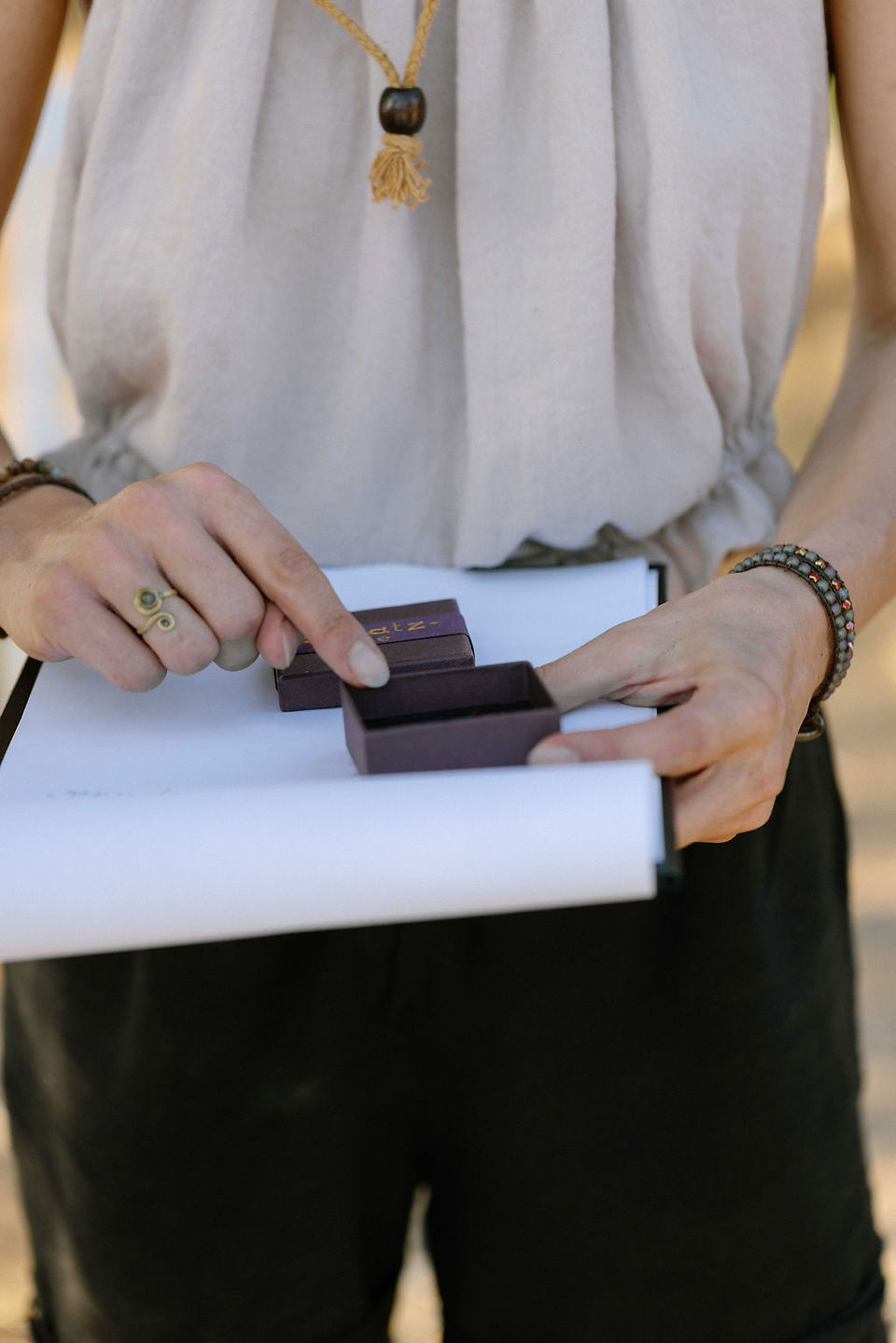 woman hands schow in open box with clue for private treasure hunt