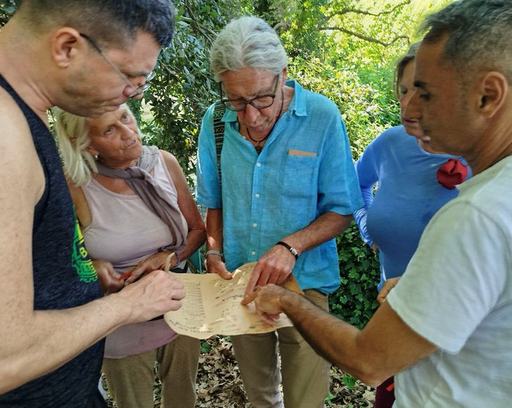 group looks on handmade maps to find the nature path for the scavenger hunt in Crete Apokoronas Chania