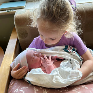 little girl holding baby