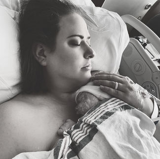 mom holding newborn baby on chest
