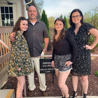 four people smiling together