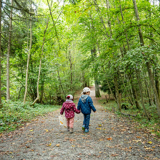 Two kids hiding through the forest
