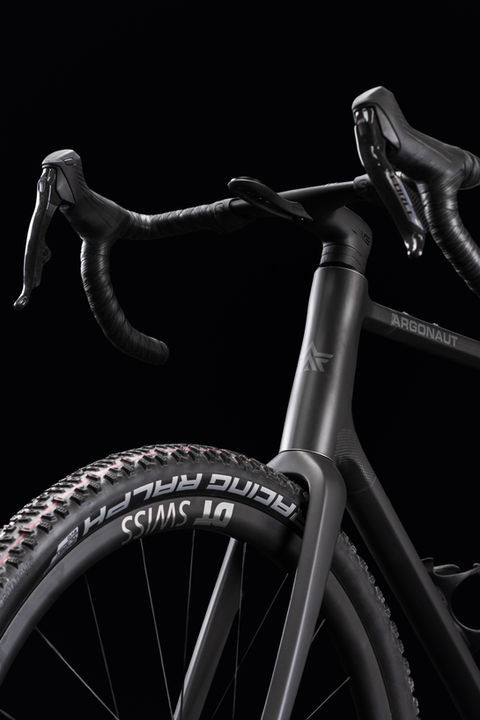 Close-up of an Argonaut custom gravel bike headtube in raw carbon cerakote