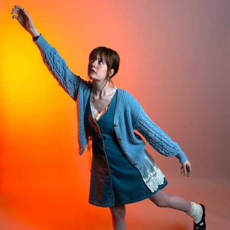 Woman reaches for orange light