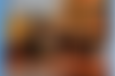 A group of business people in hard hats on a rooftop terrace