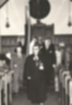 Pastor leading procession down church aisle
