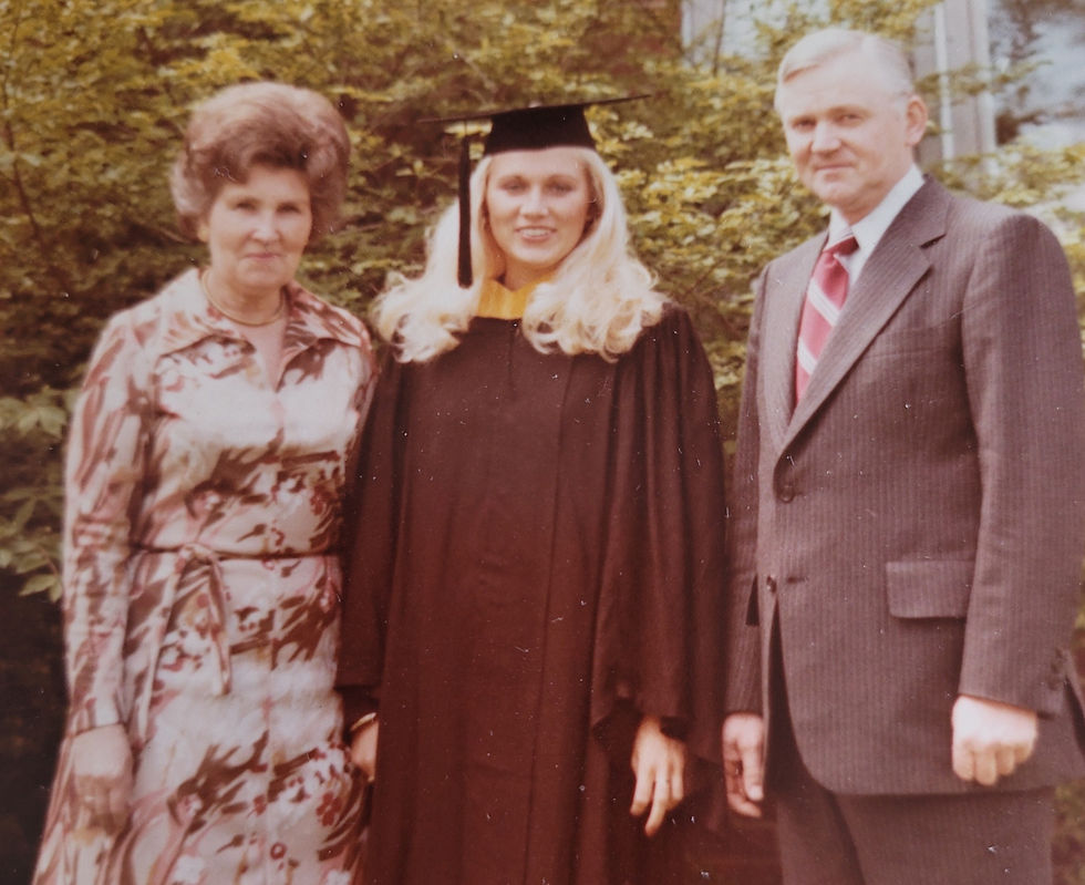 Tiina with her parents at college graduation
