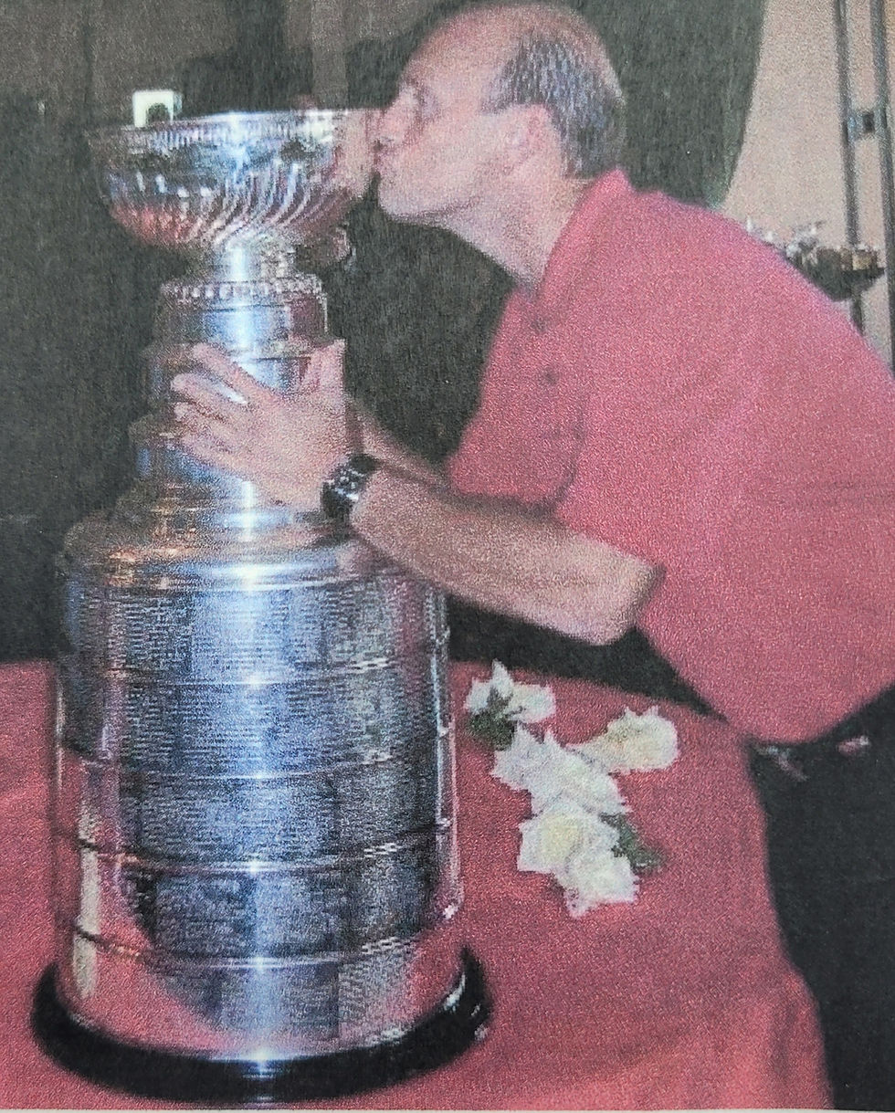 Andrus, an avid hockey fan, with the Stanley Cup