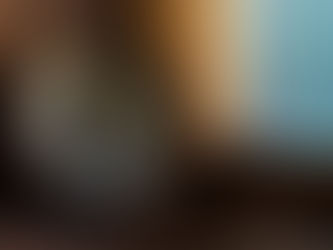 Antique brass compass beside a wooden window frame with frosted glass.