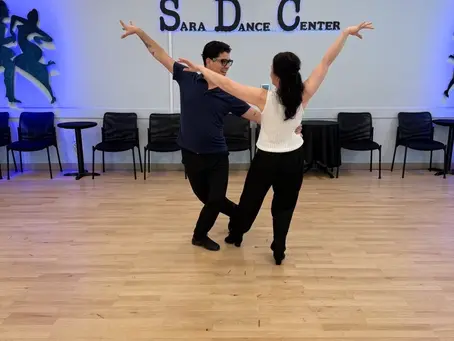 Instructor leading a private ballroom dance lesson with an adult student in Sarasota, Florida.