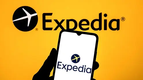 Expedia app on a smartphone screen against a yellow background