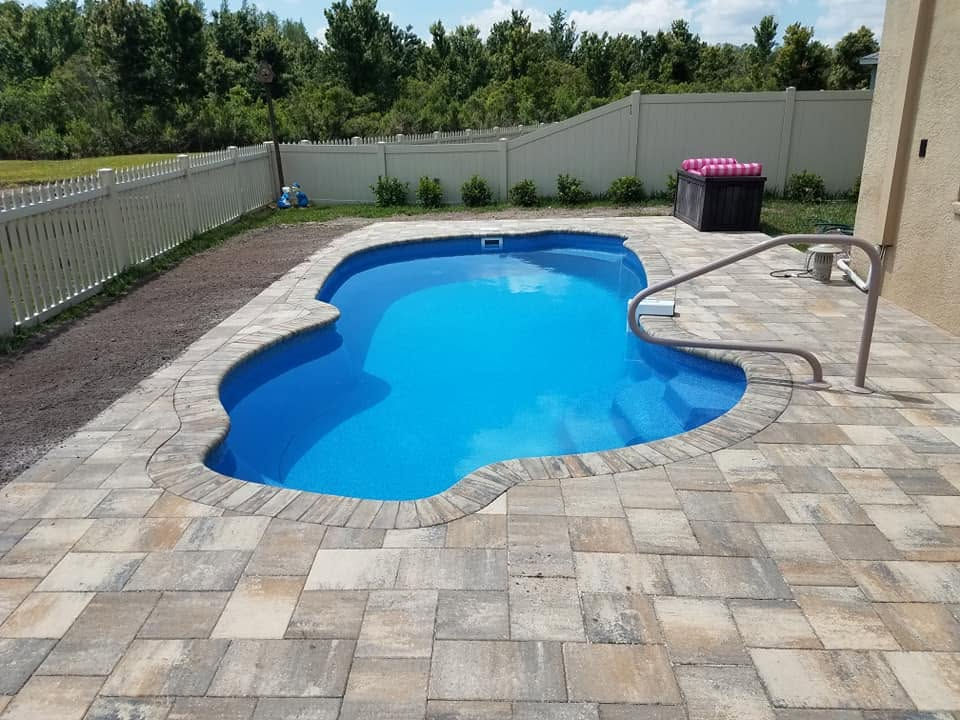 Fiberglass pool with a finished paver deck