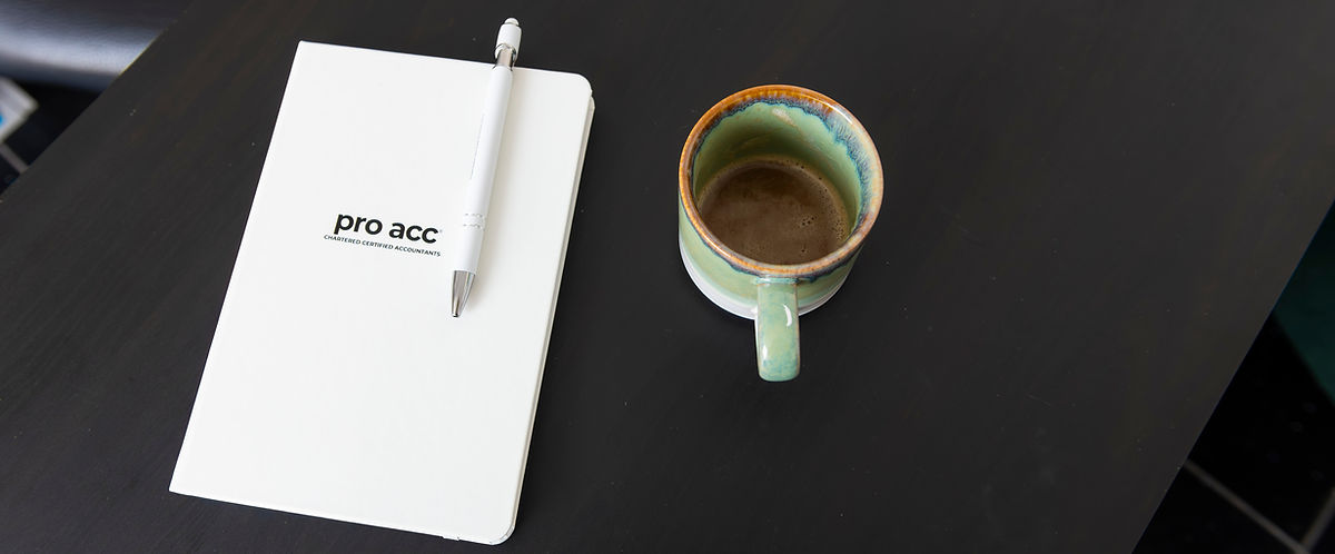 Pro Acc notebook next to coffee