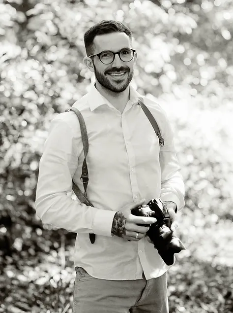 Devon wedding photographer, Toby Lidstone Photography, holding a camera
