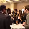 Diverse attendees networking and discussing at a professional conference