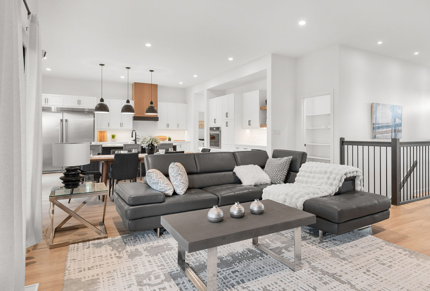 Living room at 20 Ash Cove with open view toward the kitchen, bright windows, and modern interior finishes.