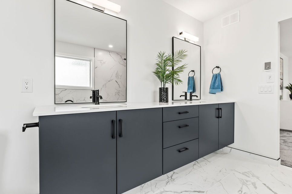 Primary ensuite at 34 Firestone Drive with black double vanity, white countertop, square mirrors, black fixtures, and marble-look flooring.