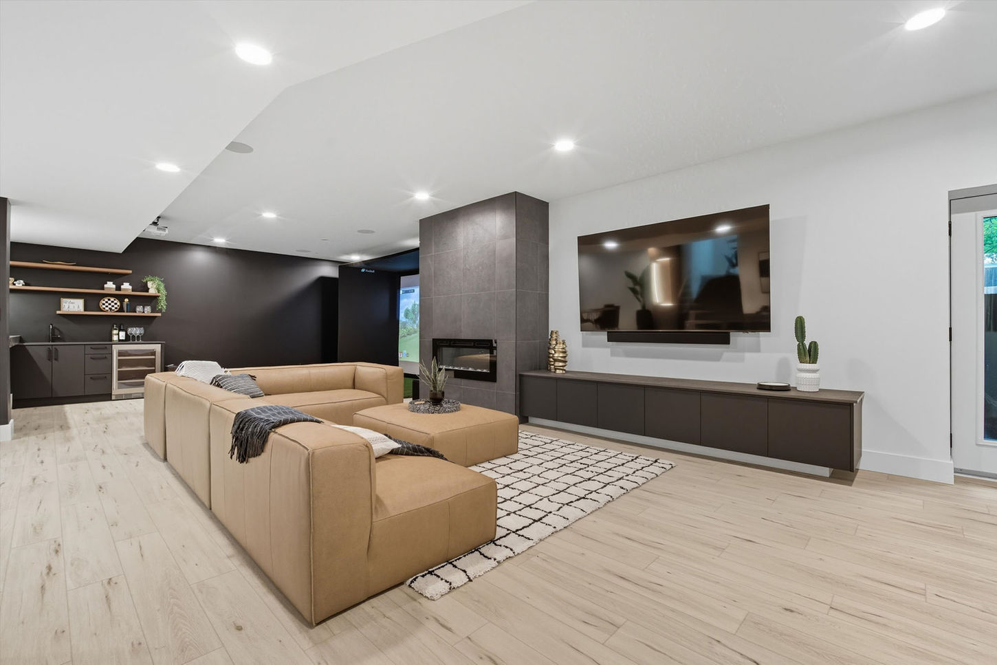 Basement entertainment area at 514 Bower Boulevard with fireplace, lounge space, and modern finishes.