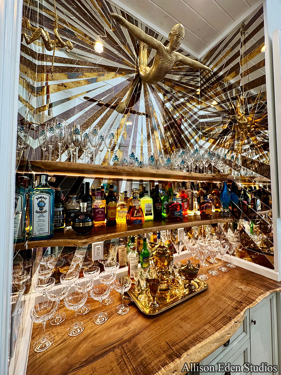 Working with a client to make their dream come true is Allison Eden's dream come true. 
Our client sold their beautiful upstate NY boutique hotel and wanted to make their Florida dream home spectacular- naturally, the bar was the place to start with the remainder of the home radiating out from that point. We love making designs that radiate out from a single point !!! This design features custom mirror colors adorned with breathtaking wall mounted fixtures that transport the cocktail party into another dimension. Precision designed for continuous patterns seamlessly wrapping adjacent surfaces makes it look effortless but a lot of planning went into this little bar area. Original, unique, bespoke, fabulous- just like our very special clients and their new dream home