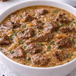 A rich, oven-braised beef stew with deep French onion flavor, finished with milk and cream cheese for a creamy, savory broth that reheats beautifully.