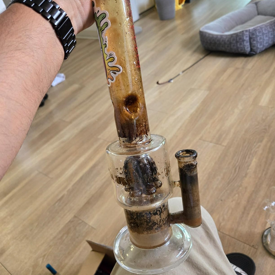 Dirty glass water pipe with heavy resin buildup before cleaning with Formula 710 Advanced Cleaner