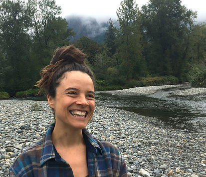 somatic therapist smiling with river and trees in background
