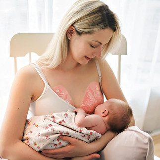 mom breastfeeding baby and using gel pads on breast