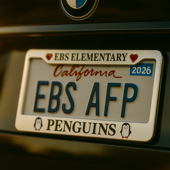 Picture of the EBS license plate holder .  The word EBS Elementary is preceded and followed by heart emojis on the top of the holder and on the bottom is the word penguins with a cartoon penguin image preceding and following the words.