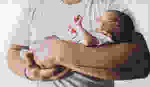Father holding sleeping baby