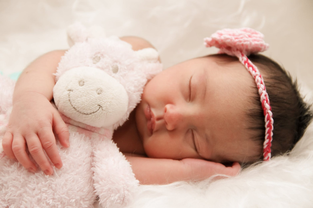 Baby sleeping with a toy
