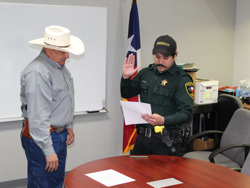 Sheriff James Villanueva swears in a Reserve Deputy Sheriff
