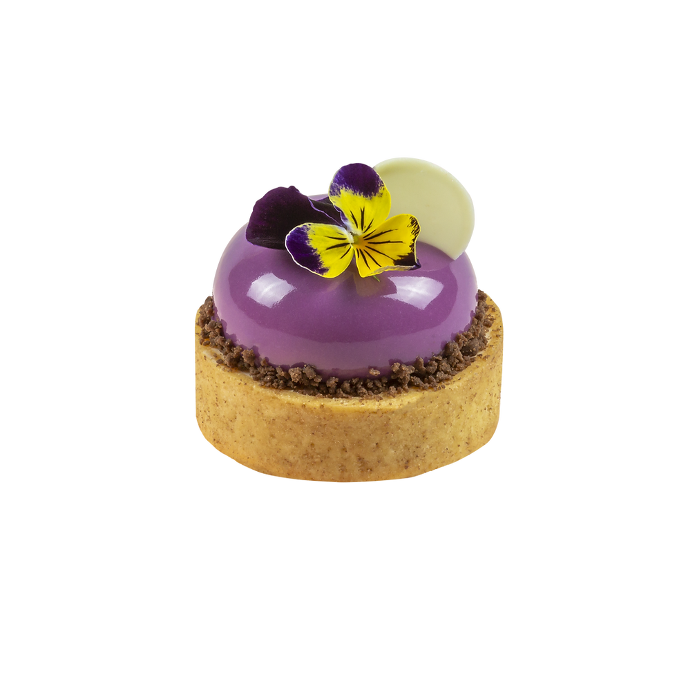 Purple glazed dessert tart with edible flower