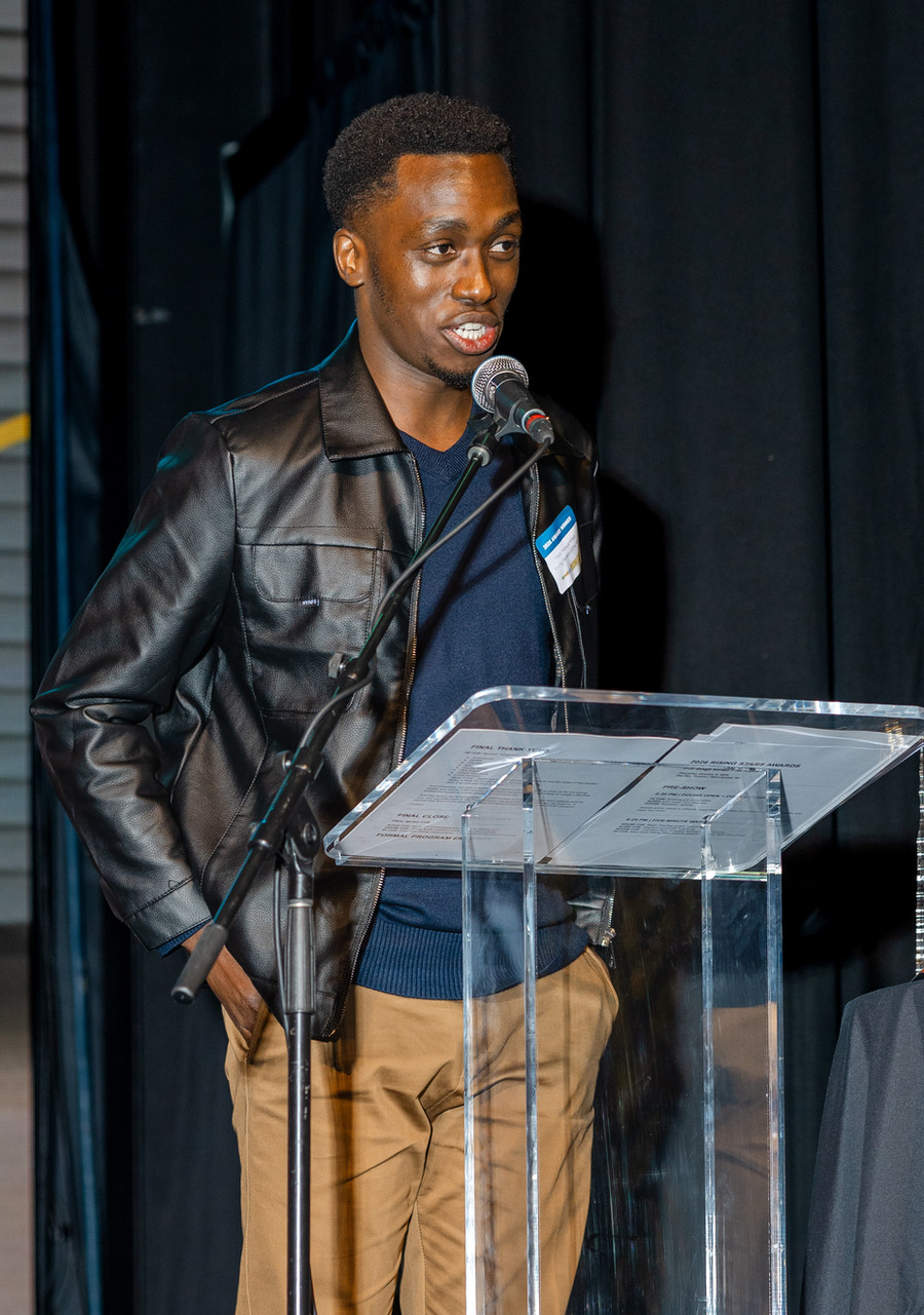 Fiston Ndayishimiye speaking at the podium at the Stay Work Play Rising Stars Awards.