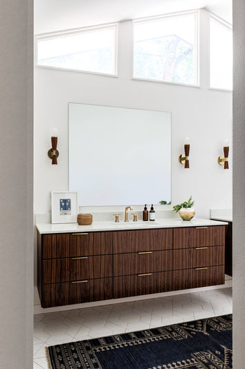 Floating walnut vanity with midcentury modern accents.