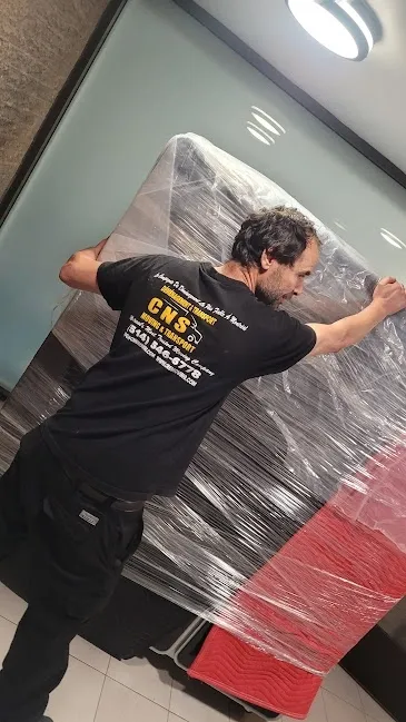Mover carefully handling wrapped MGI medical instrument
