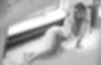 A woman wearing lingerie laying on a white carpet