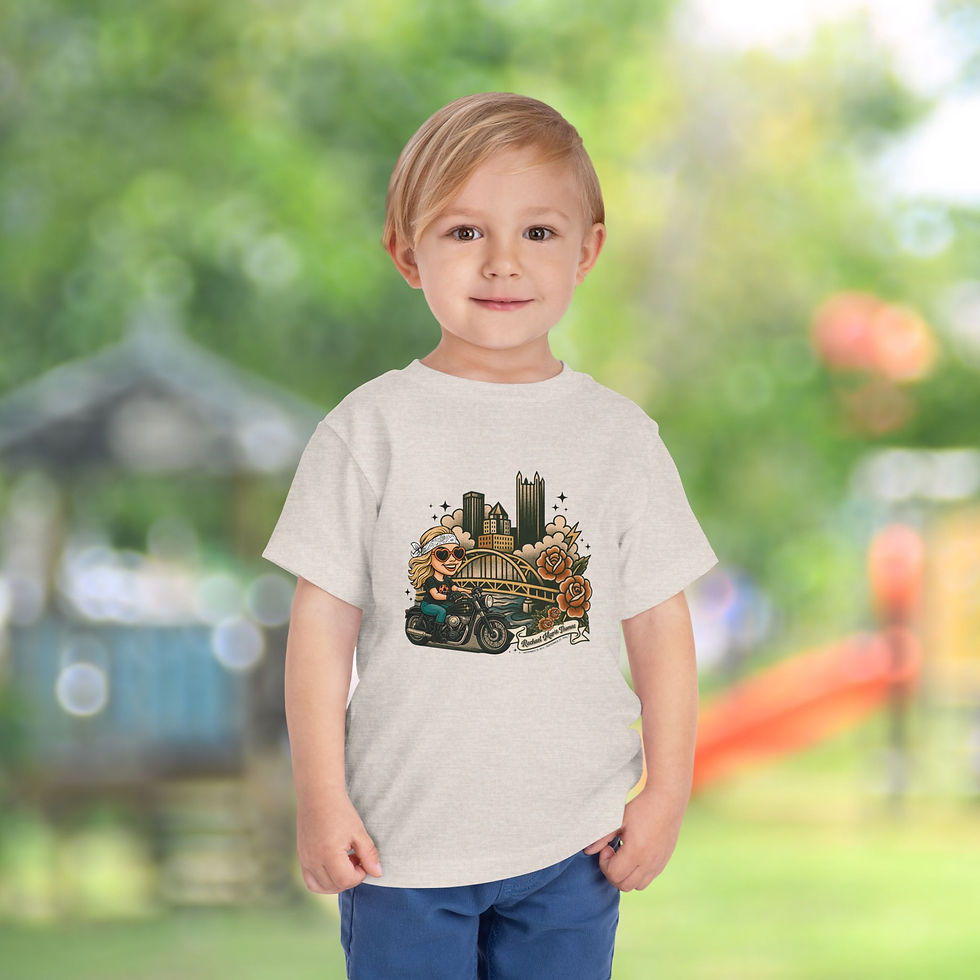 Thumbnail: Toddler wearing a Remembering Rachael Thomas 2025 Memorial Toddler Tee, standing against a blurred background.
