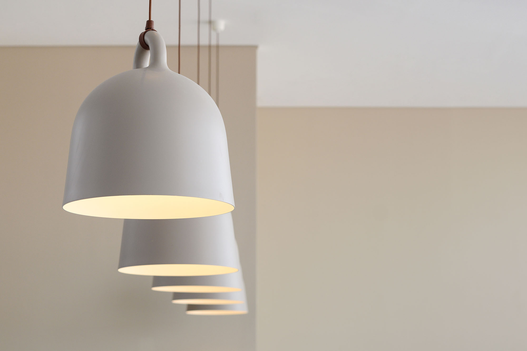 A sequence of softly illuminated pendant lights at Kyoto Coffee Shop