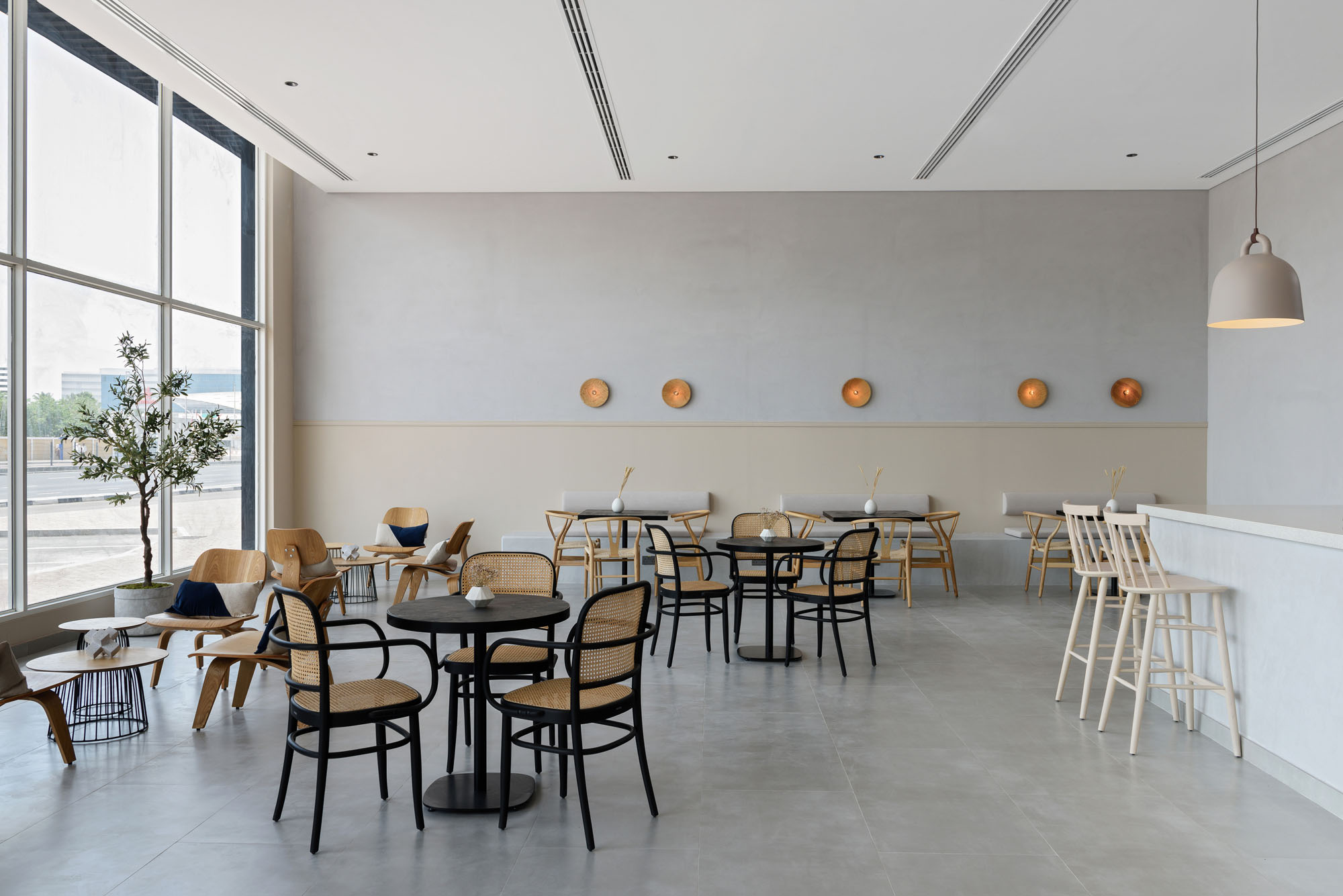 Kyoto Coffee Shop interior with timber seating, small round tables and natural daylight
