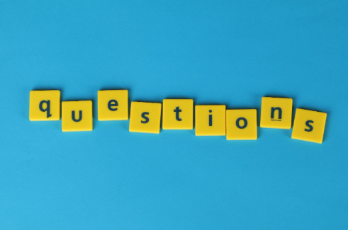 Yellow letter blocks spelling out "questions" against a blue background.